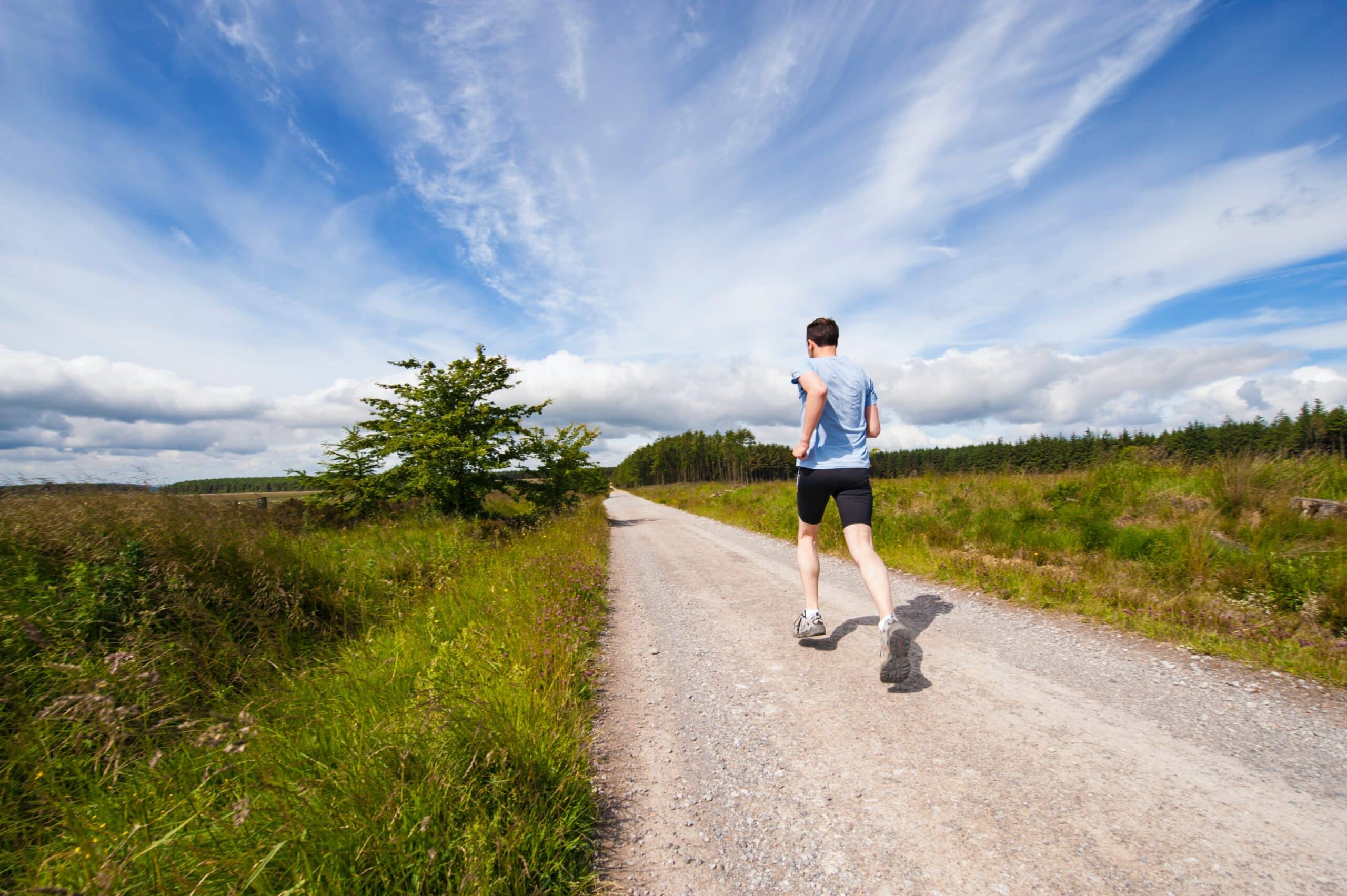 man jogging on a gravel road